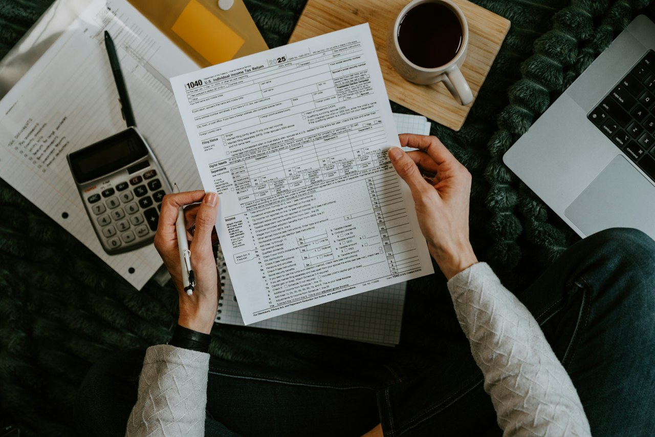 Tax records and a laptop on a desk, part way through a quarter